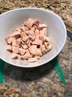 Chop leftover chicken breast.
